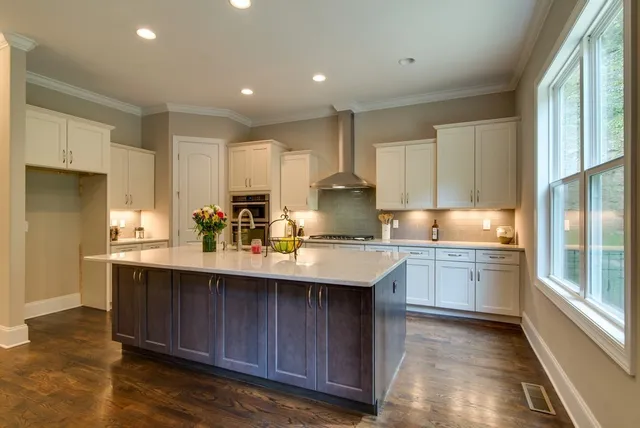 a kitchen with stainless steel appliances granite countertop a stove refrigerator and microwave