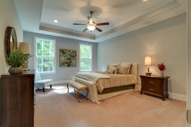 a bedroom with a bed closet and a chandelier