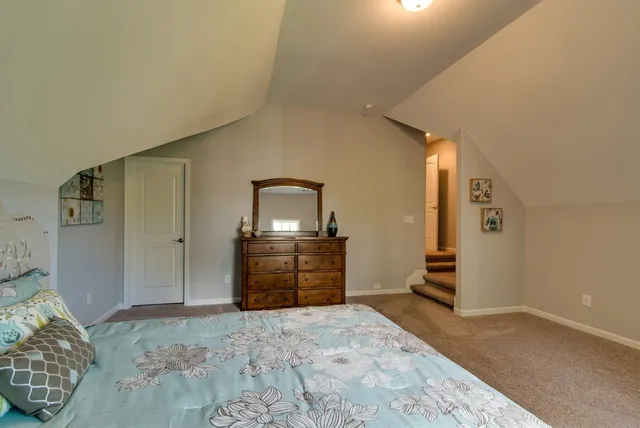 a bathroom with a granite countertop sink a toilet and shower