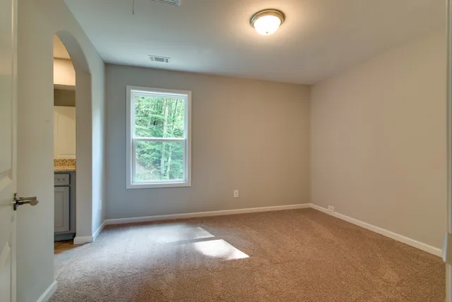 a bathroom with a granite countertop sink and a toilet