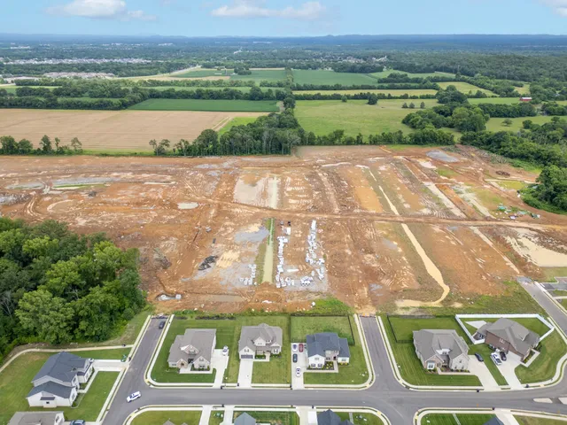an aerial view of a houses with ocean view