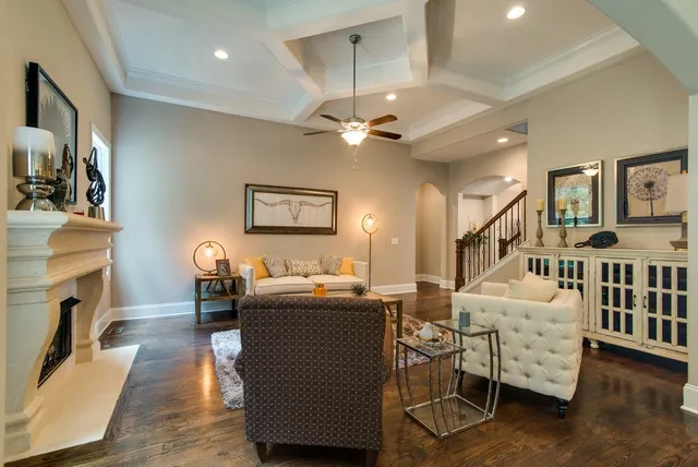 a living room with furniture a table and a chandelier