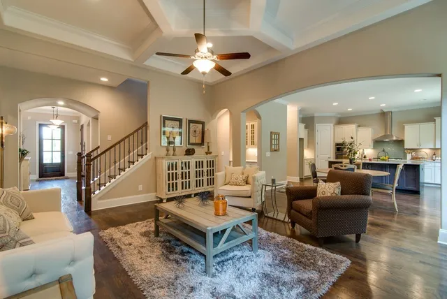 a kitchen with a dining table chairs and wooden floor