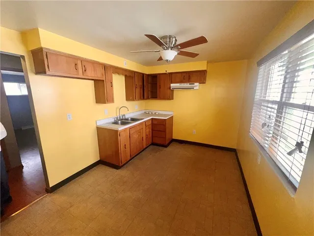 a view of a kitchen with a sink cabinet and a window