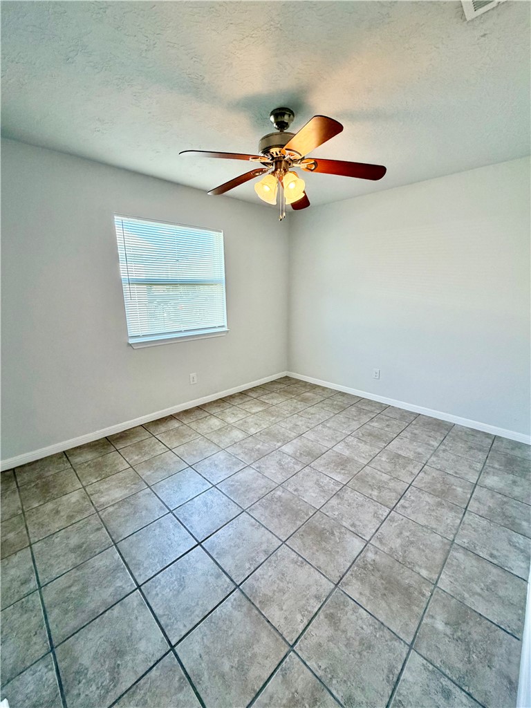 1900-1910 Finfeather Road Bryan, TX 77801 - Photo 13 of 20 an empty room with windows and fan