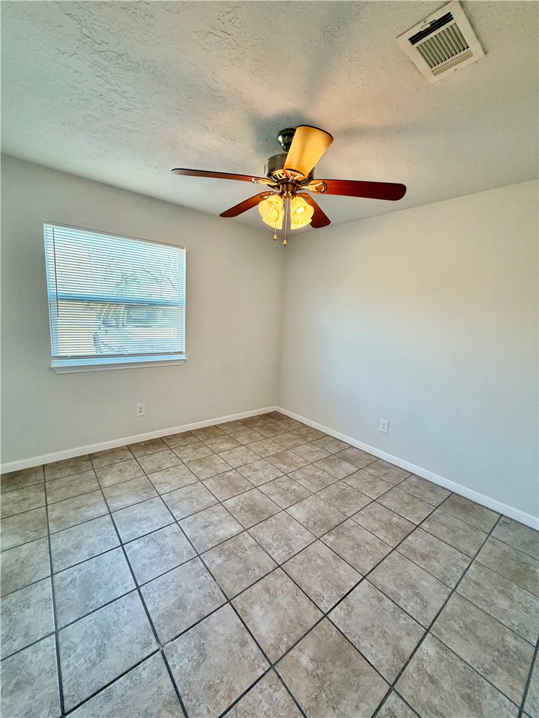 1900-1910 Finfeather Road Bryan, TX 77801 - Photo 16 of 20 an empty room with a window and a chandelier fan