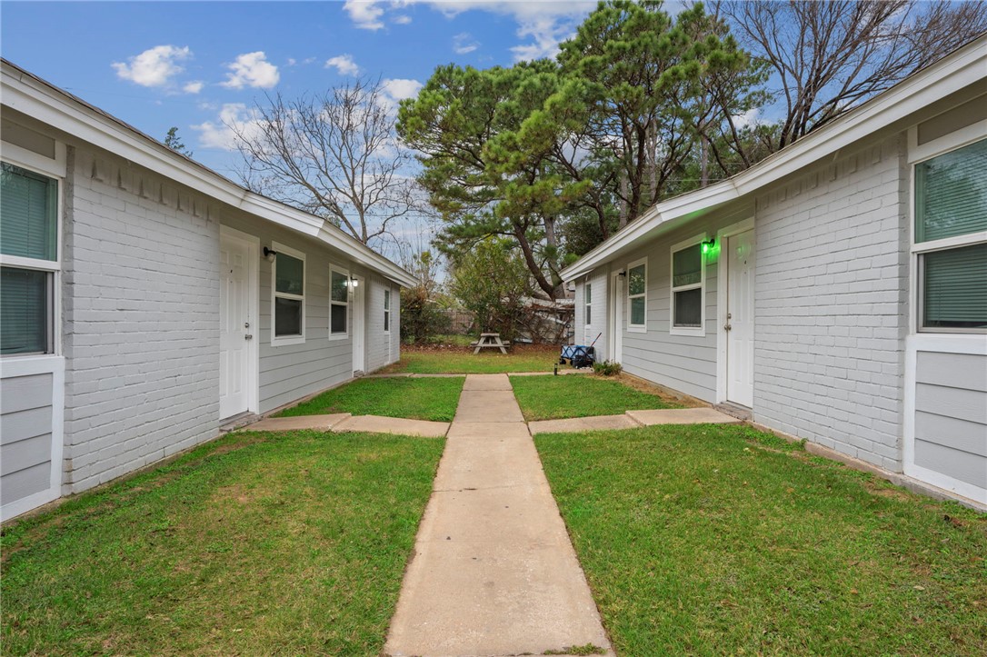 1900-1910 Finfeather Road Bryan, TX 77801 - Photo 5 of 20 a view of a yard with a house and a large tree