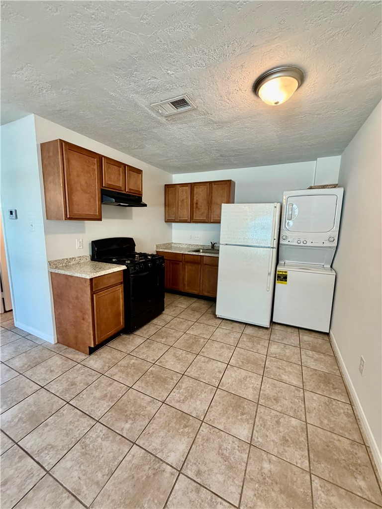1900-1910 Finfeather Road Bryan, TX 77801 - Photo 9 of 20 a kitchen with stainless steel appliances a stove a sink and a refrigerator