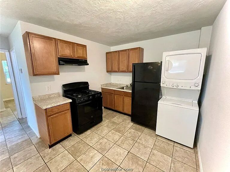 1900-1910 Finfeather Road Bryan, TX 77801 - Photo 10 of 20 a kitchen with a refrigerator stove and microwave
