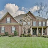 front view of a brick house with a yard
