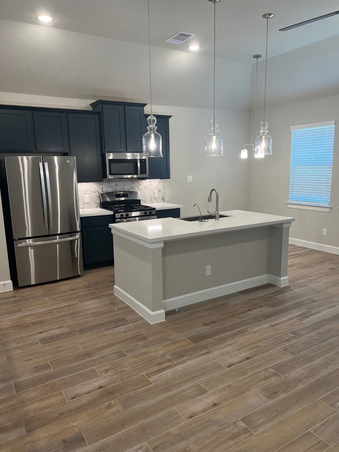 3316 Vine Ter Trace Houston, TX 77047 - Photo 10 of 18 a large kitchen with granite countertop a stove and a refrigerator