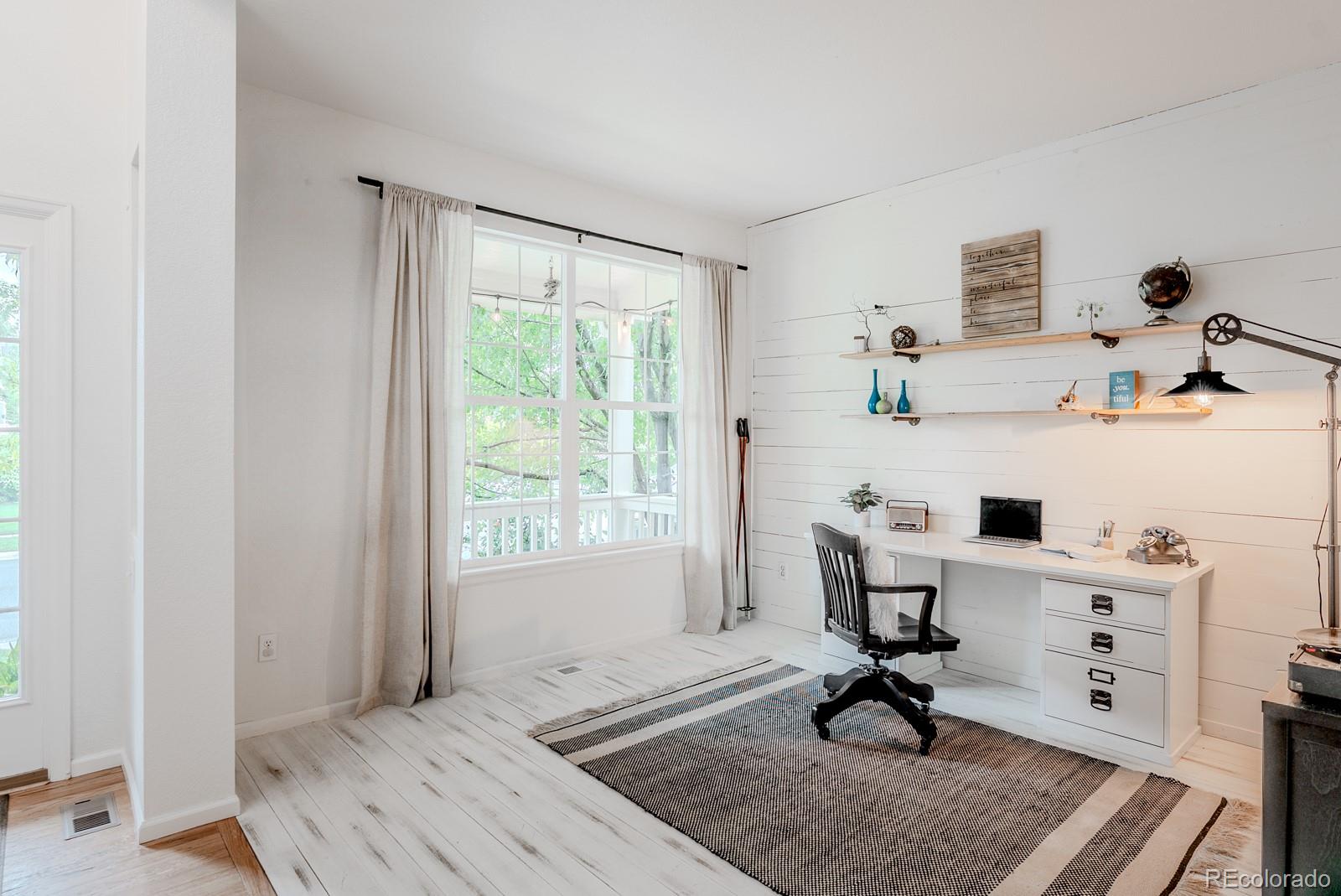 8367 Devinney Street Arvada, CO 80005 - Photo 14 of 41 a view of a workspace with furniture and a window