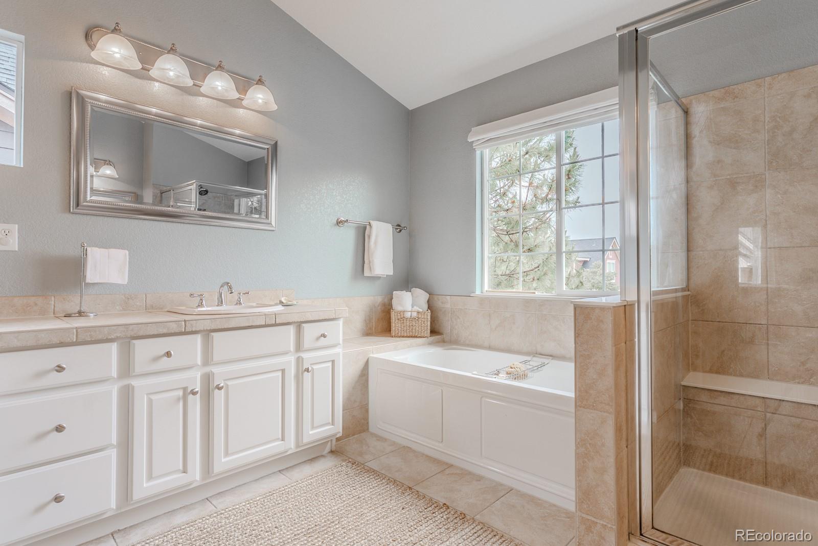 8367 Devinney Street Arvada, CO 80005 - Photo 20 of 41 a bathroom with a sink and a mirror