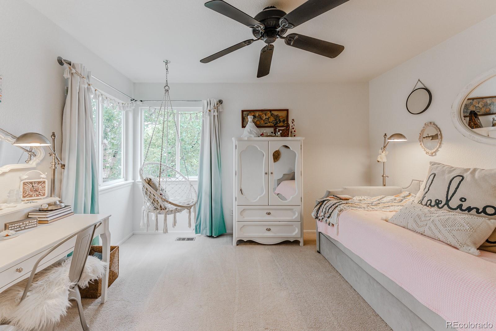 8367 Devinney Street Arvada, CO 80005 - Photo 21 of 41 a bedroom with a bed and a chandelier