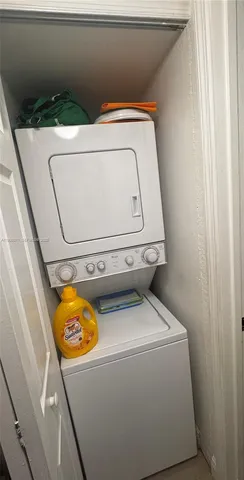 a living room with stainless steel appliances kitchen island granite countertop furniture and a large window