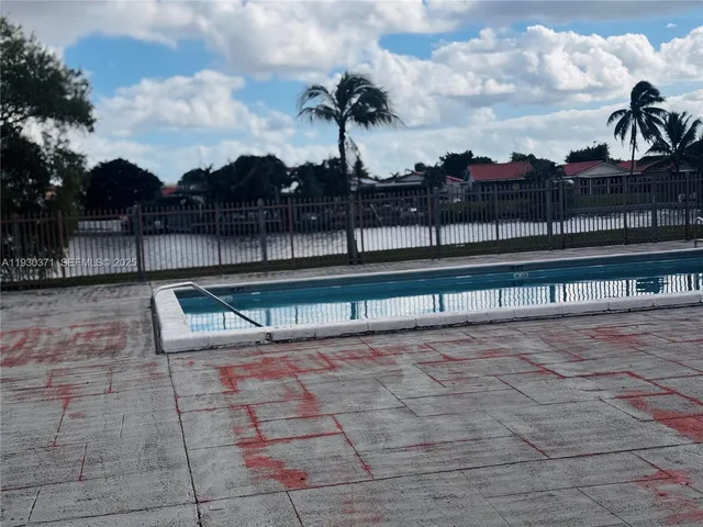 a view of swimming pool with outdoor seating and plants