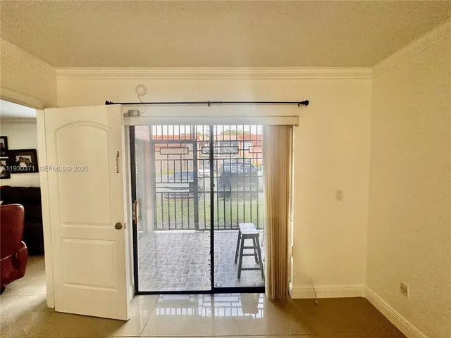 a view of a porch with a door and a yard
