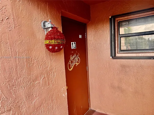 a living room with furniture and a refrigerator