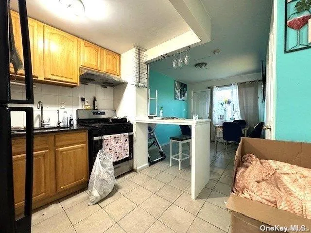 a kitchen with stainless steel appliances kitchen island granite countertop a refrigerator and microwave