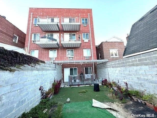 a view of a brick building next to a yard