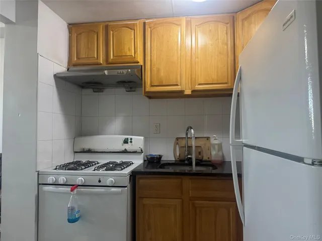 a kitchen with a stove and a refrigerator