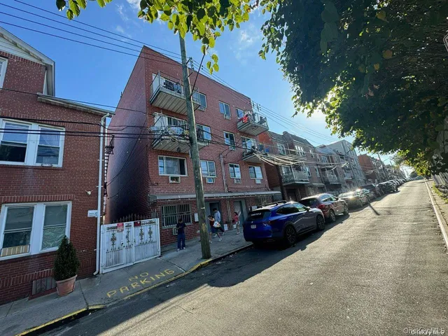a couple of cars parked in front of a building
