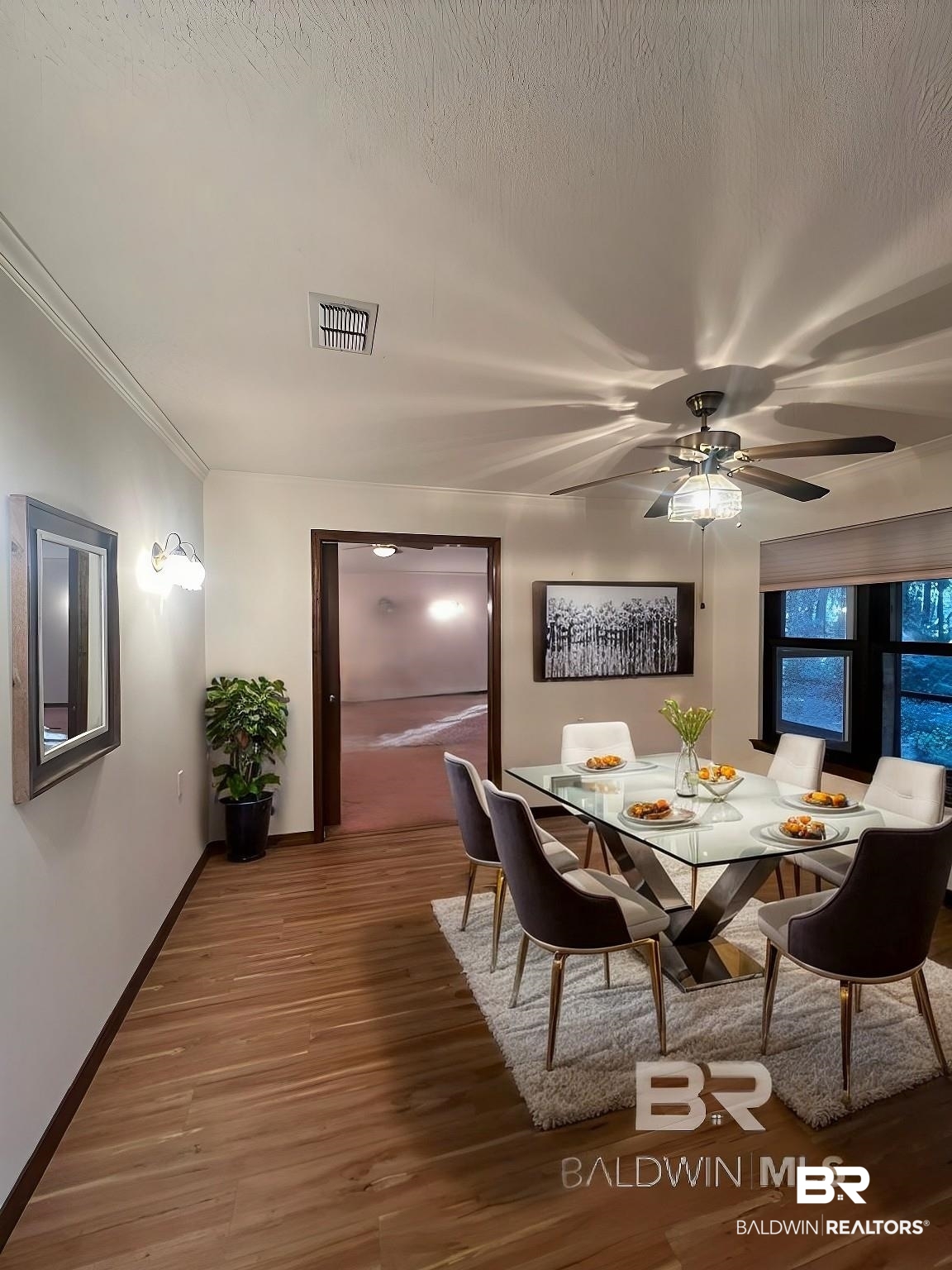 2682 Pine Ridge Drive Lillian, AL 36549 - Photo 7 of 37 Dining space featuring a textured ceiling, hardwood / wood-style flooring, ceiling fan, and crown molding