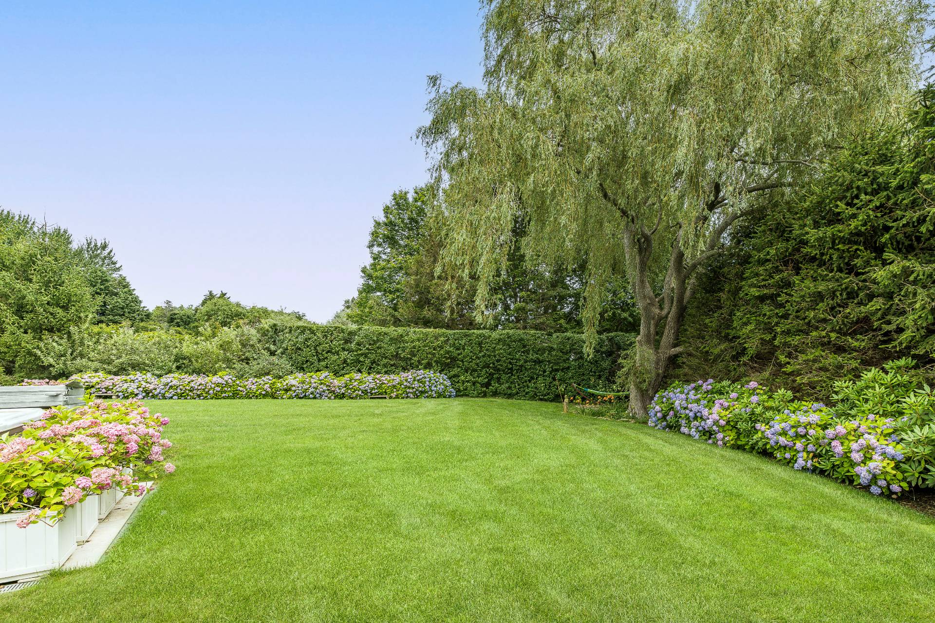 24 South Potato Barn Road Water Mill, NY 11976 - Photo 41 of 42 a view of a garden with a lake