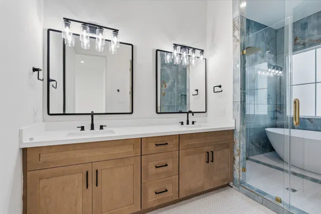 a bathroom with a double vanity sink mirror double and bathtub