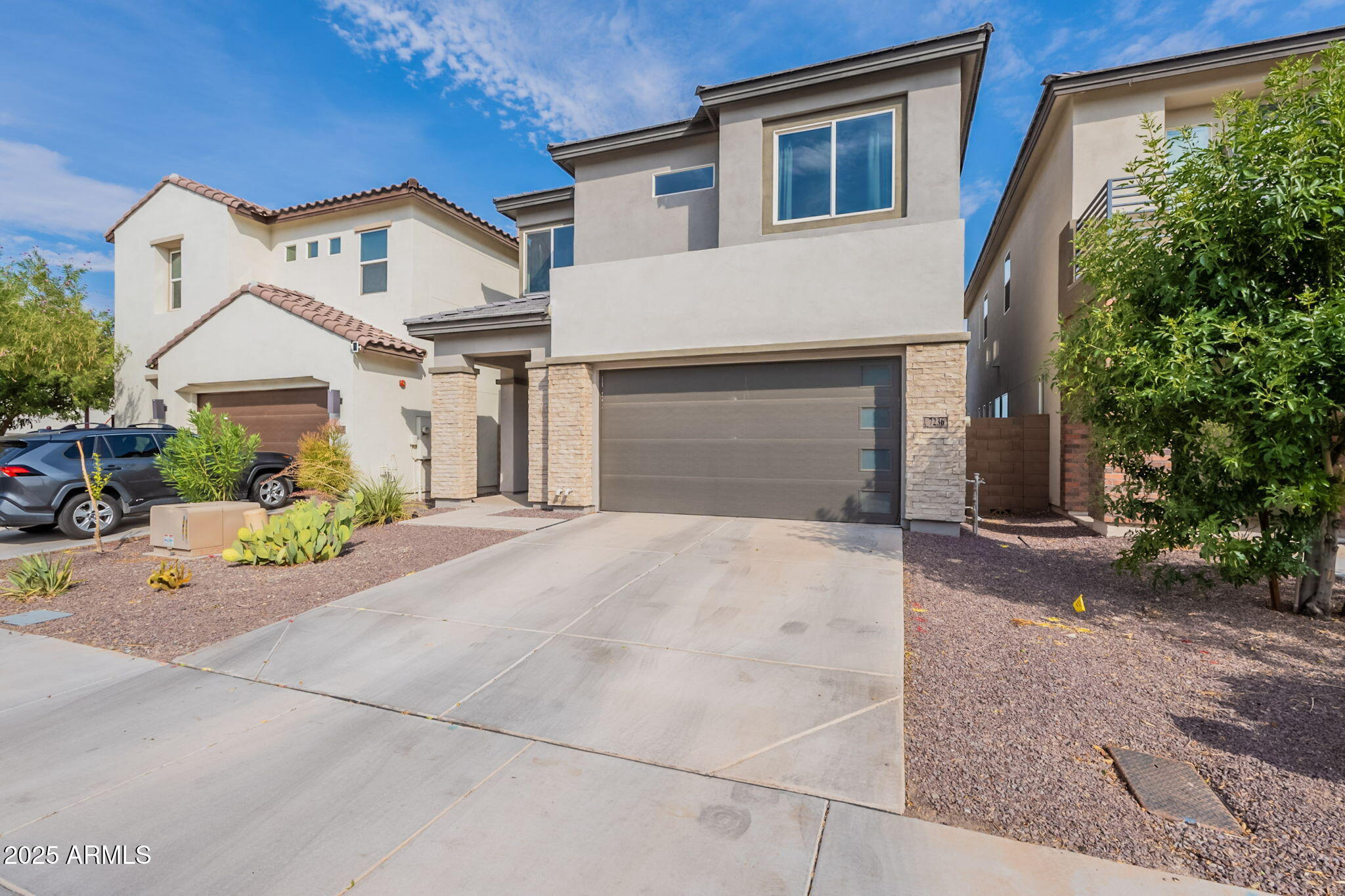 a front view of a house with a yard and garage