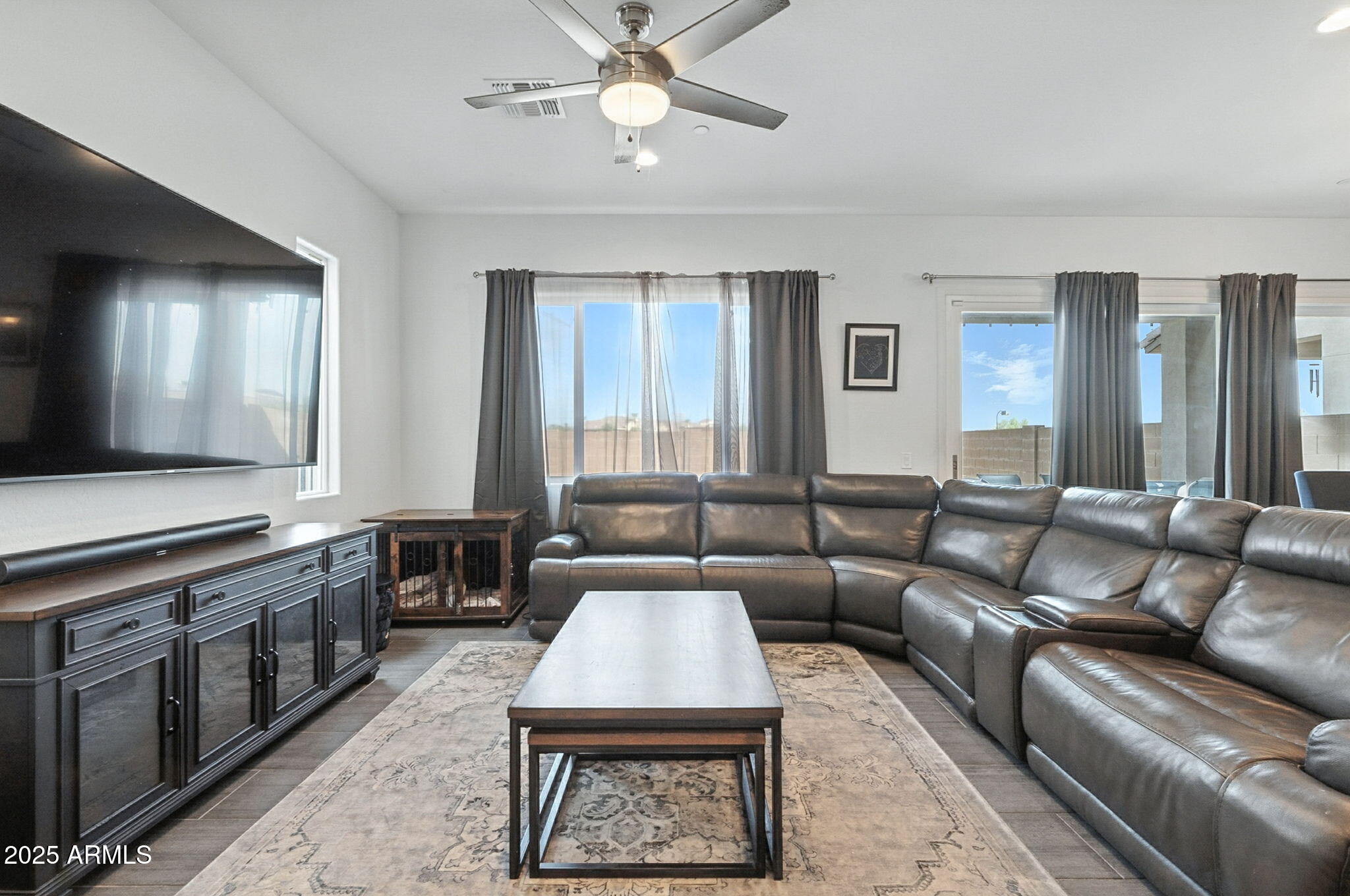 7236 West Phelps Road Peoria, AZ 85382 - Photo 12 of 53 a living room with furniture and a flat screen tv