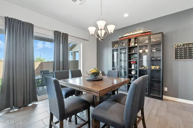 a view of a dining room with furniture and chandelier