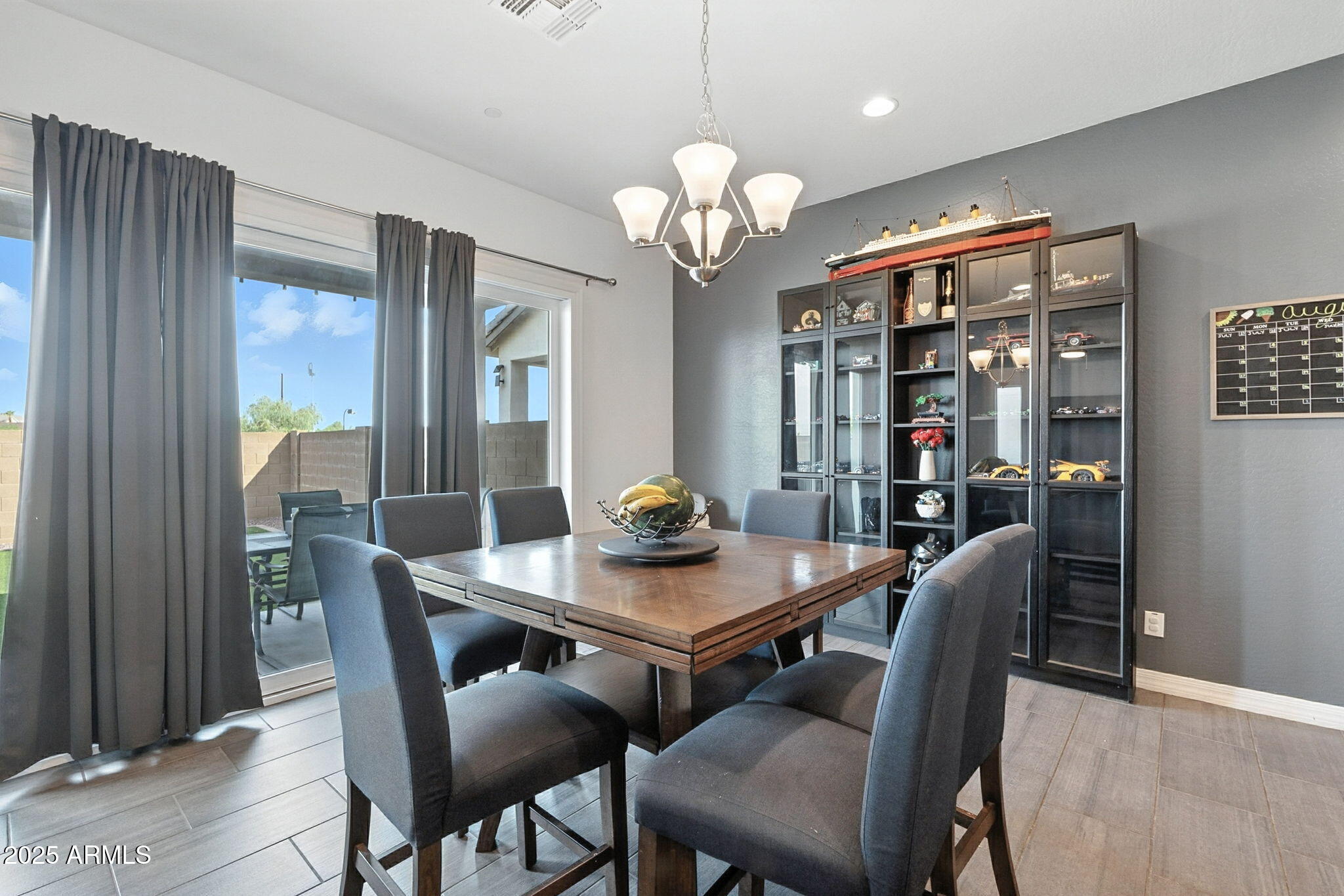 7236 West Phelps Road Peoria, AZ 85382 - Photo 13 of 53 a view of a dining room with furniture and chandelier