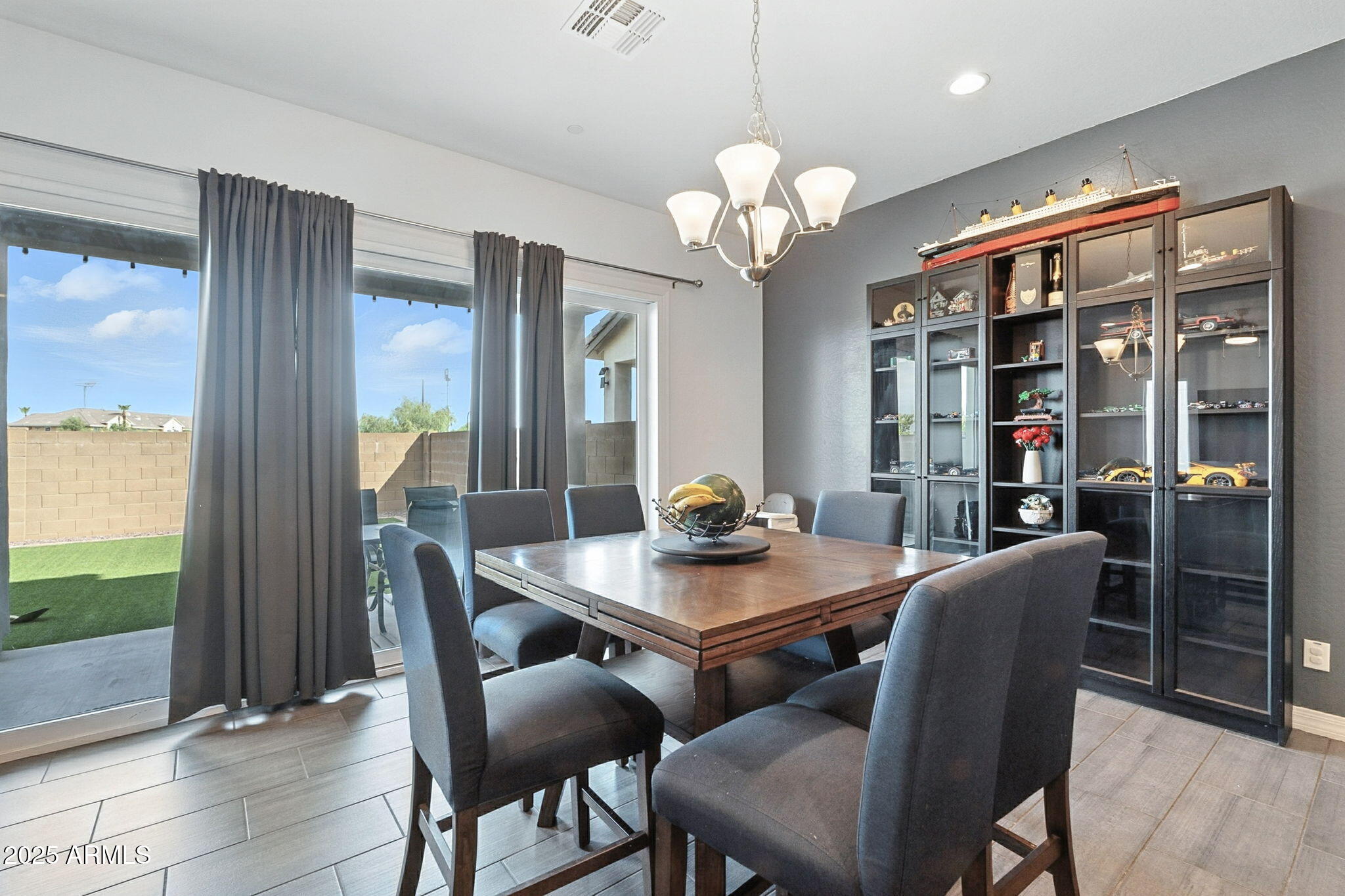 7236 West Phelps Road Peoria, AZ 85382 - Photo 14 of 53 a view of a dining room with furniture window and wooden floor