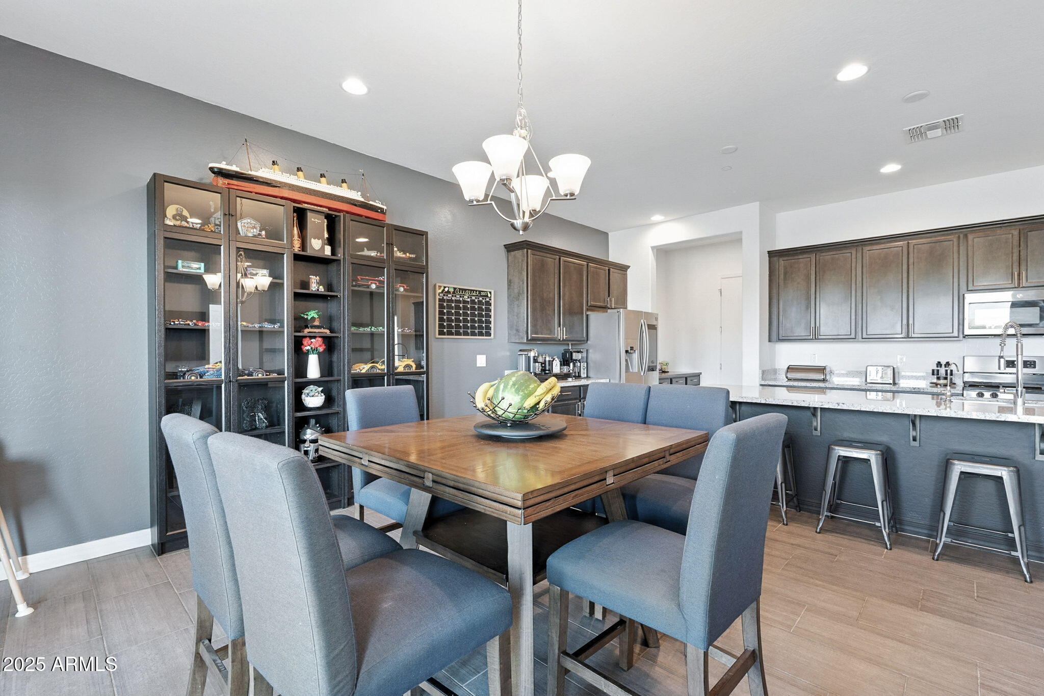 7236 West Phelps Road Peoria, AZ 85382 - Photo 15 of 53 a view of a dining room with furniture and wooden floor