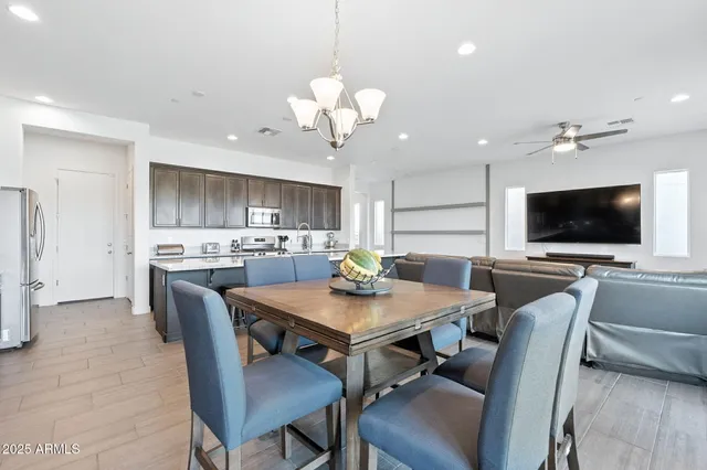 a view of a dining room with furniture and a flat screen tv