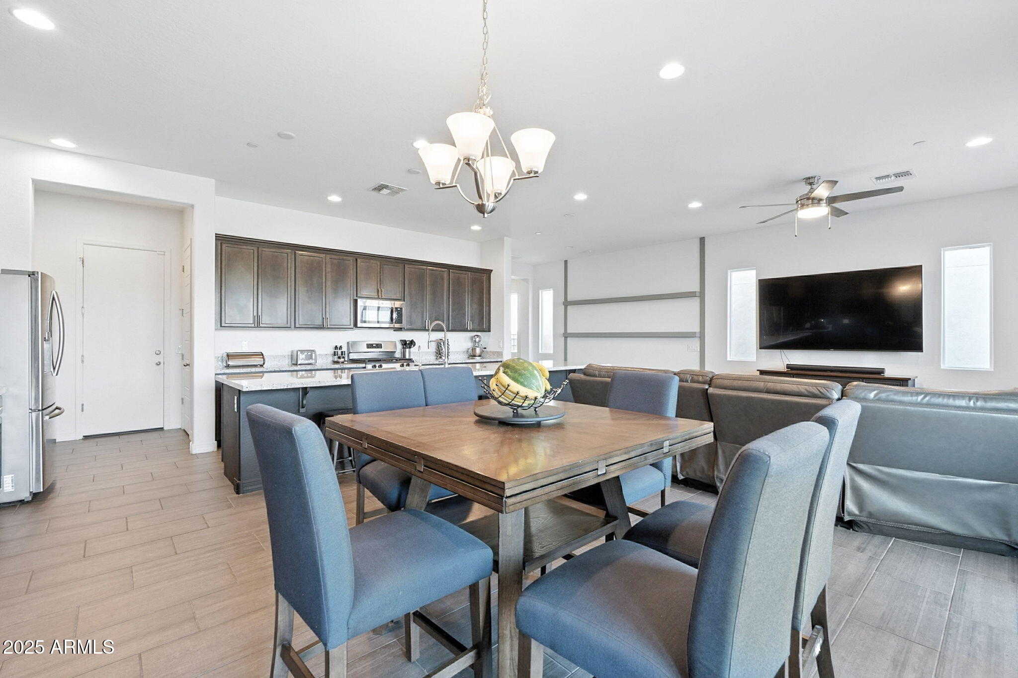 7236 West Phelps Road Peoria, AZ 85382 - Photo 16 of 53 a view of a dining room with furniture and a flat screen tv