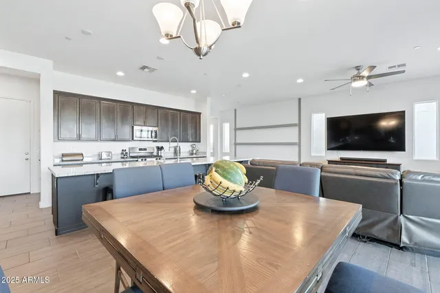 a kitchen with a table chairs and microwave