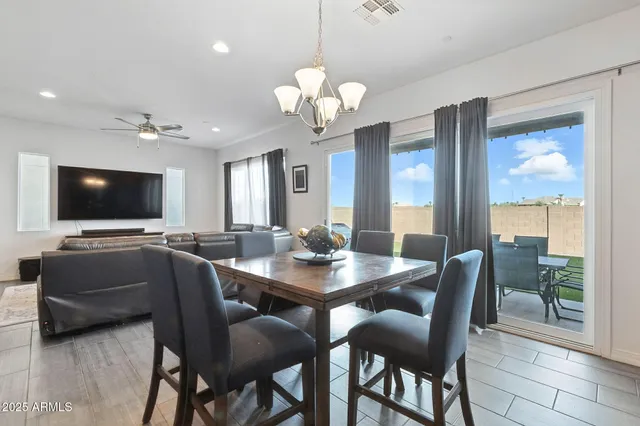 a view of a dining room with furniture and a chandelier