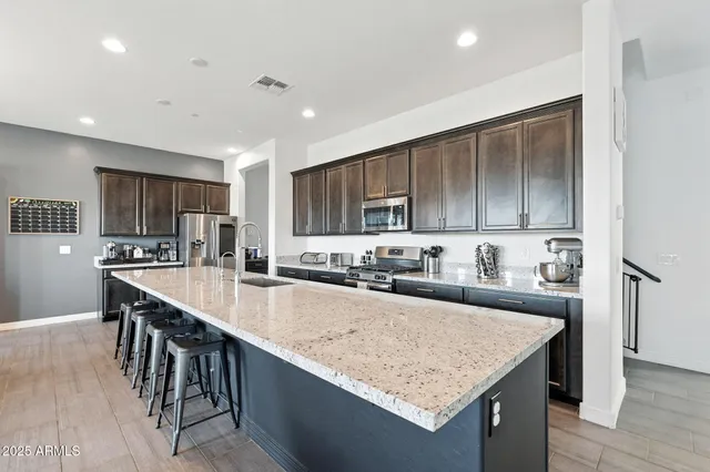a kitchen with stainless steel appliances granite countertop counter space and wooden cabinets