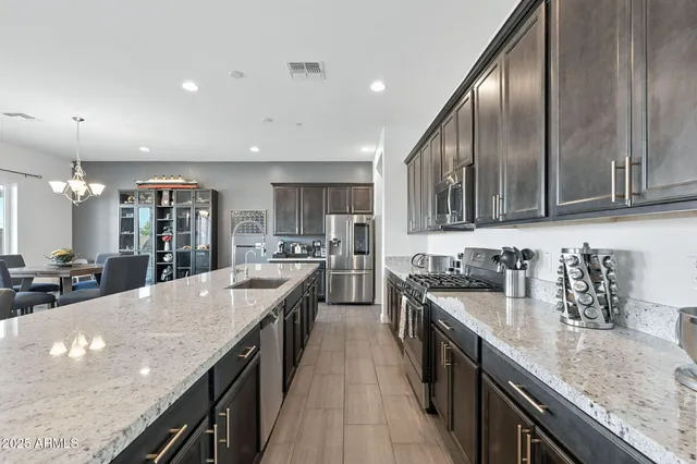 a kitchen with stainless steel appliances granite countertop counter space a sink and cabinets