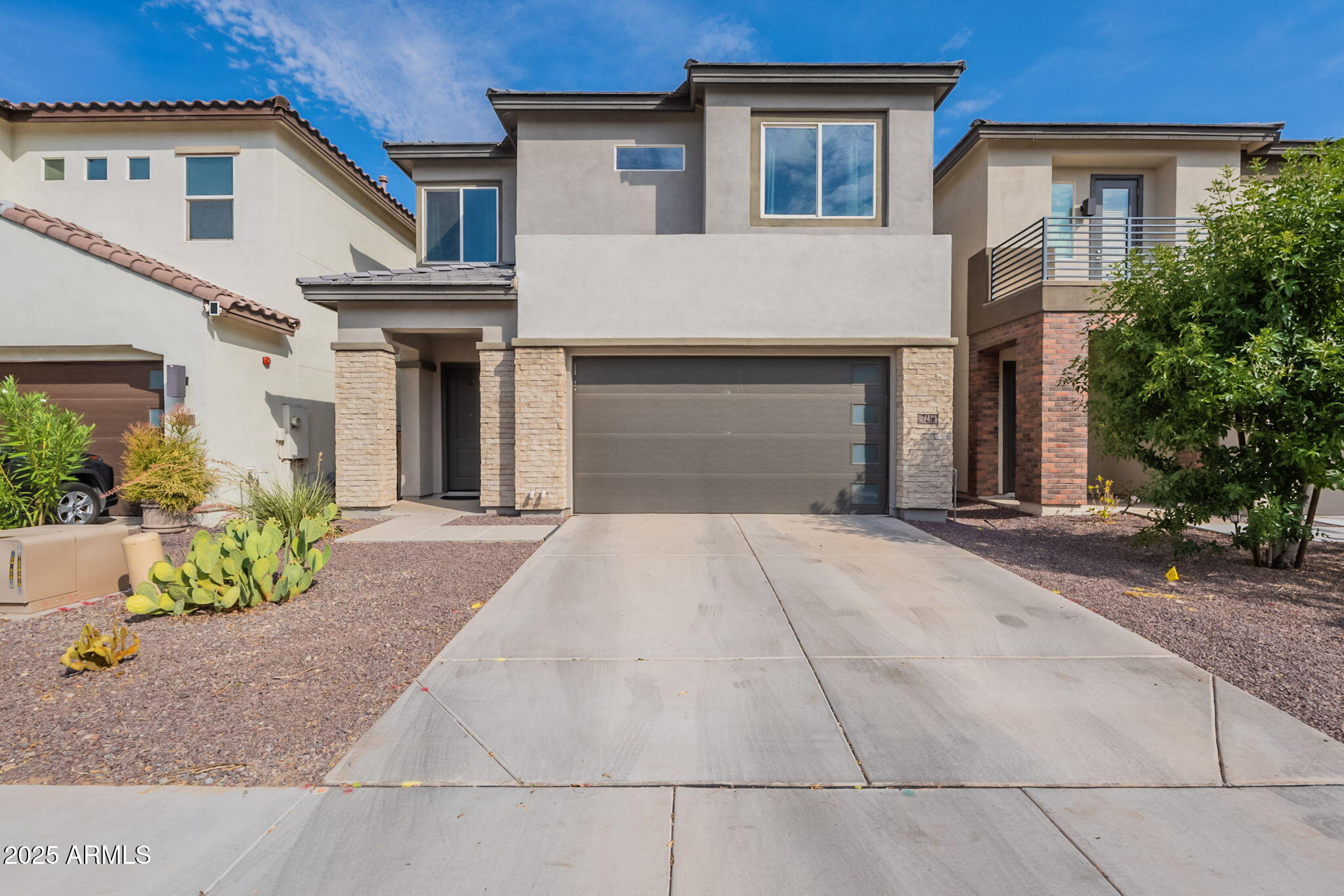 7236 West Phelps Road Peoria, AZ 85382 - Photo 2 of 53 a front view of a house with a yard and a garage