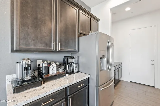 a kitchen with stainless steel appliances granite countertop a refrigerator and a sink