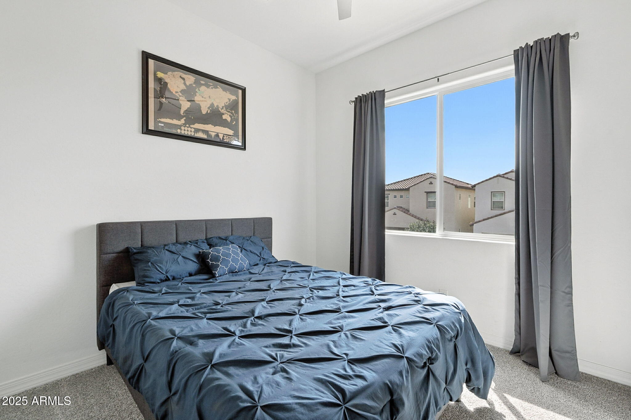 7236 West Phelps Road Peoria, AZ 85382 - Photo 28 of 53 a large bed sitting in a bedroom next to a window