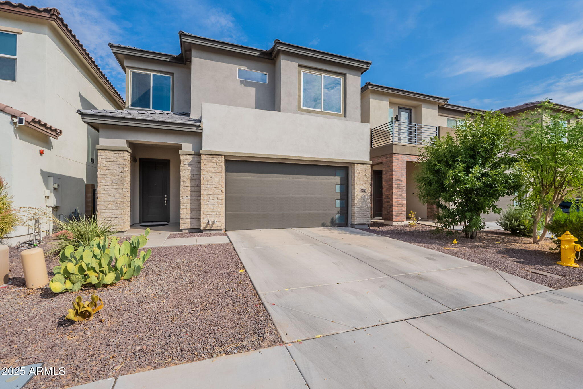 7236 West Phelps Road Peoria, AZ 85382 - Photo 3 of 53 a front view of a house with a yard and garage