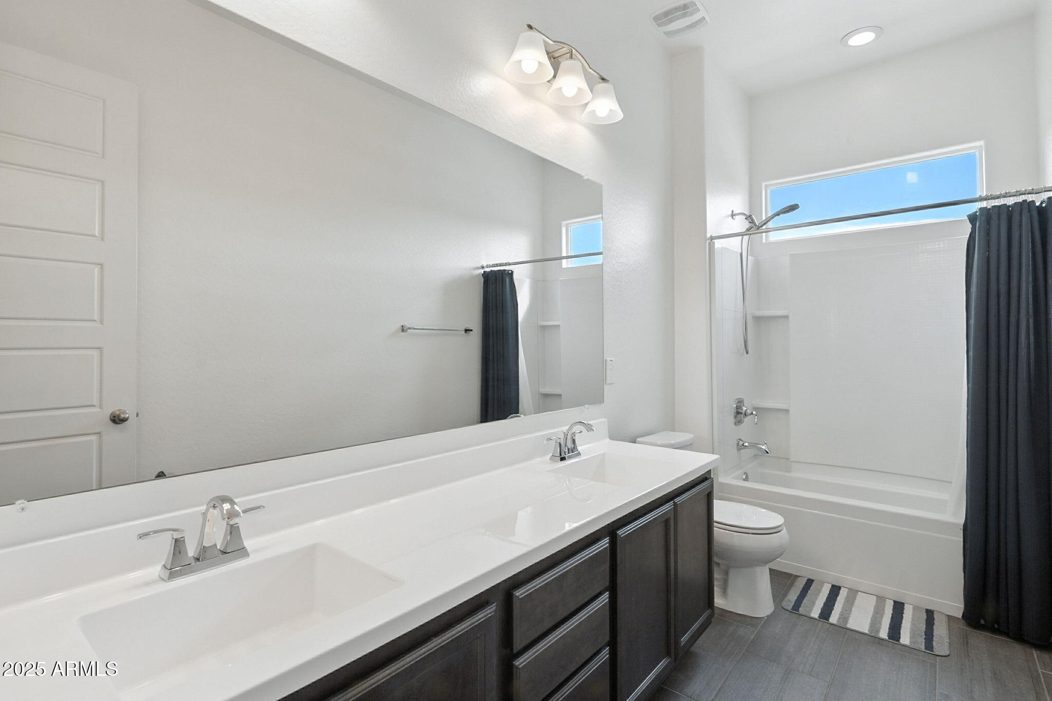 7236 West Phelps Road Peoria, AZ 85382 - Photo 32 of 53 a bathroom with a double vanity sink and a bathtub