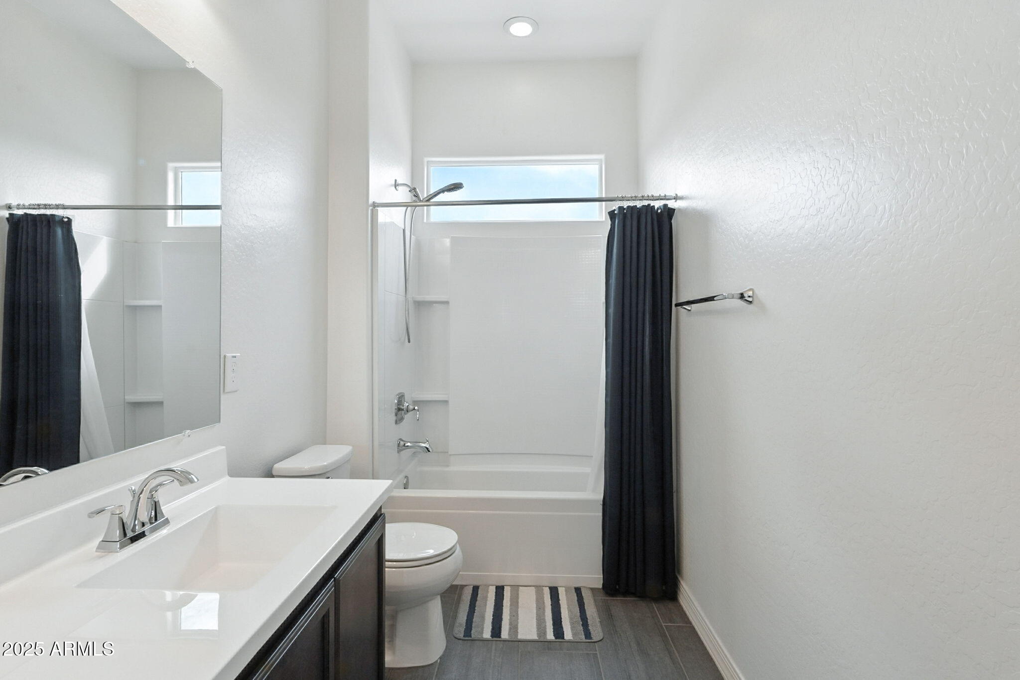 7236 West Phelps Road Peoria, AZ 85382 - Photo 33 of 53 a bathroom with a sink a toilet and shower