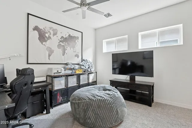a bedroom with a bed and painting on the wall