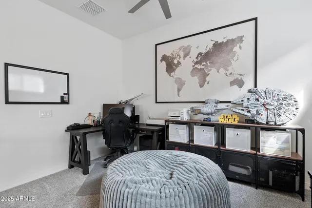 a view of a workspace with furniture and windows