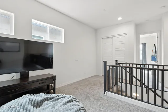 a bedroom with a bed a dresser and a window